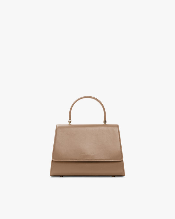 ALEXIA bag in beige, front view, flap closed, top handle raised, on white background