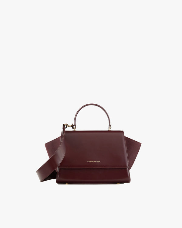 ALEXIA bag in Mahogany, front view with top handle and detached strap, side wings extended
