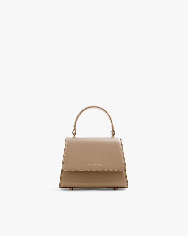 ALEXIA NANO bag in beige, front view, flap closed, top handle, on white background