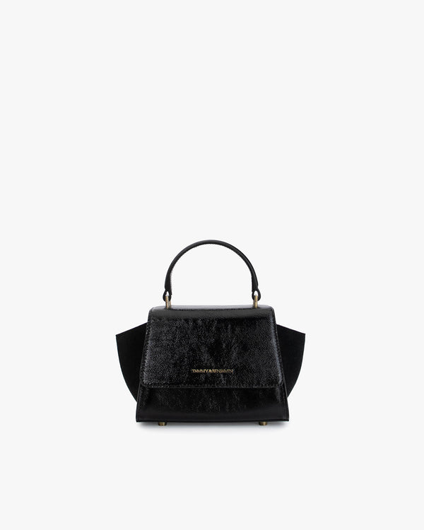 ALEXIA NANO bag in black naplak, front view, top handle, side wings and flap closure visible