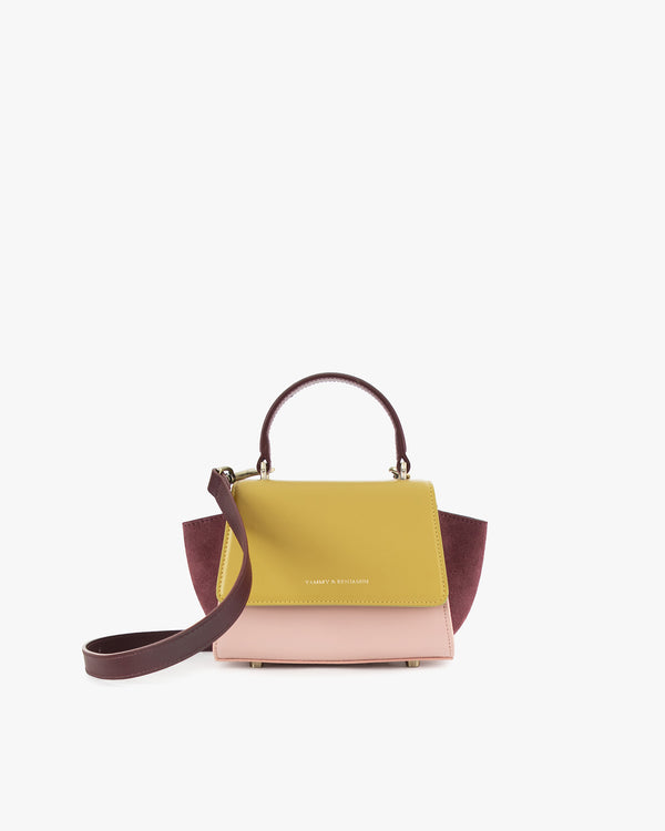 ALEXIA NANO bag in Colourblock Vesper, front view, yellow and pink flap, burgundy side wings, top handle and shoulder strap