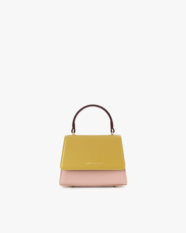 ALEXIA NANO bag in Colourblock Vesper, front view, mustard yellow flap, pink body, burgundy handle
