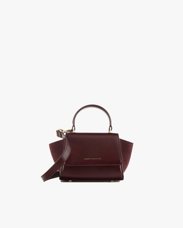 ALEXIA NANO bag in Mahogany, front view, rigid handle, side wings extended, strap detached