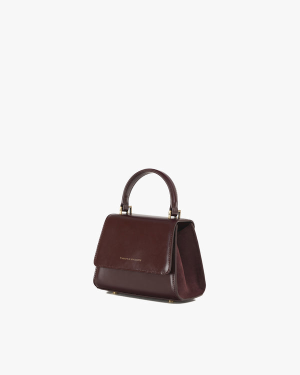 ALEXIA NANO bag in Mahogany, three-quarter view, top handle raised, side wing open showing the lining