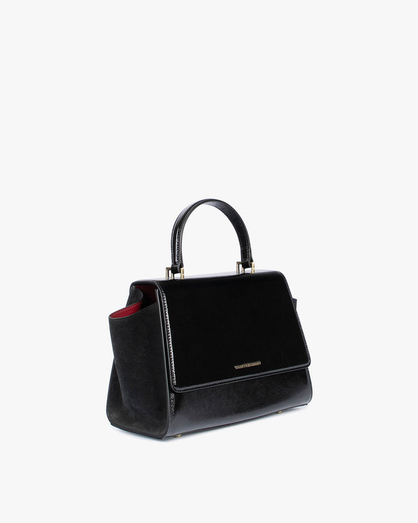 ALEXIA black naplak, three-quarter back view, side wing tucked in, top handle and gold logo visible