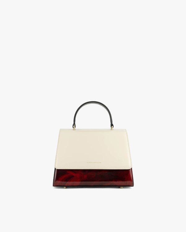ALEXIA bag in art deco colourblock, front view, black top handle, standing