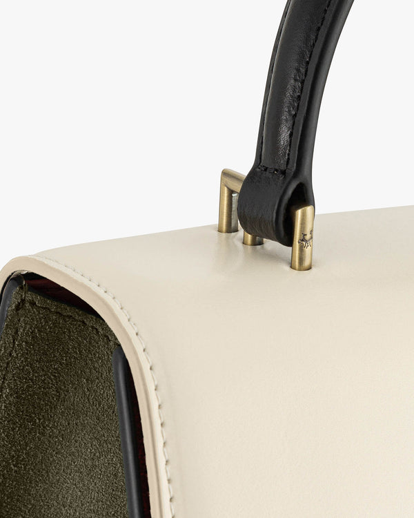 ALEXIA bag art deco colourblock, close-up of brass hardware, black handle and khaki suede lining
