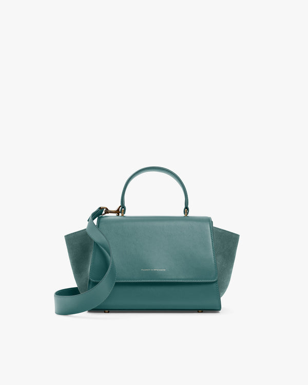 ALEXIA bag in turquoise, front view, flap closed, wings tucked in, handle and detachable strap