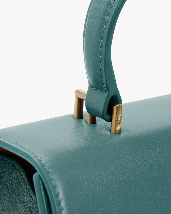 ALEXIA bag in Turquoise, close-up of the wrapped handle and aged gold-tone hardware on the flap