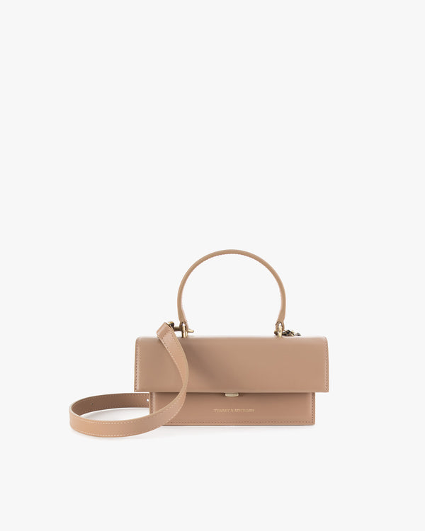 THEA MINI bag in beige, front view, closed flap, rigid handle with detachable strap resting in front