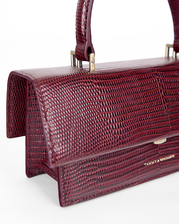 THEA MINI bag in Bordeaux embossed lizard, close-up on flap, handle and gold clasp