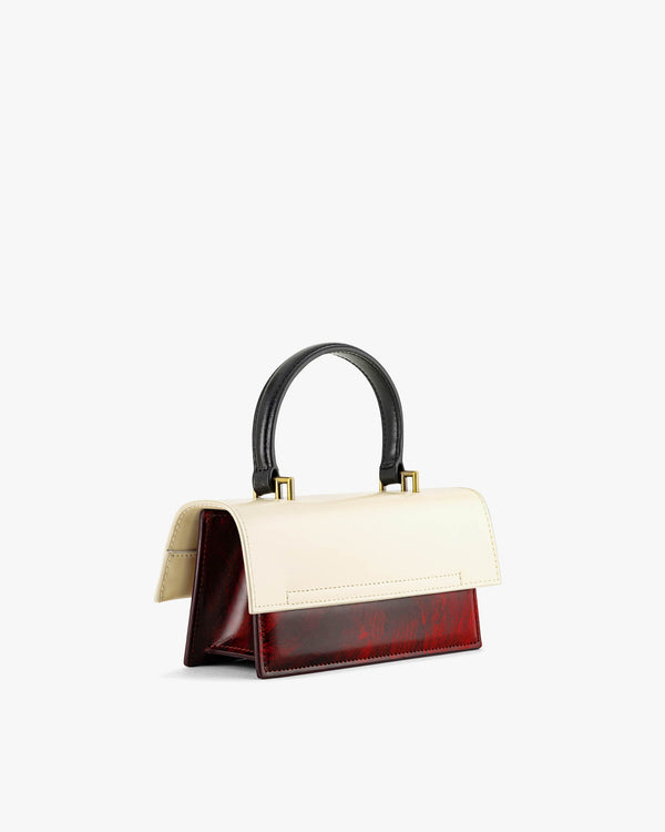 THEA MINI bag in art deco colourblock, three-quarter view, black handle, ivory flap and burgundy body