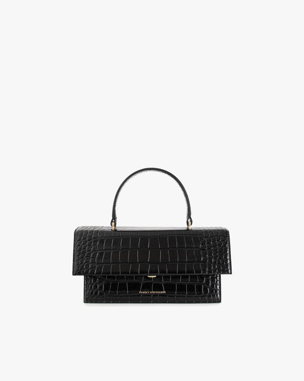 THEA bag in black croc-embossed leather, front view, standing, with top handle