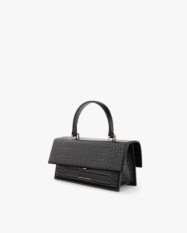 THEA bag in black croc-embossed leather, three-quarter view, top handle, oversized flap closed