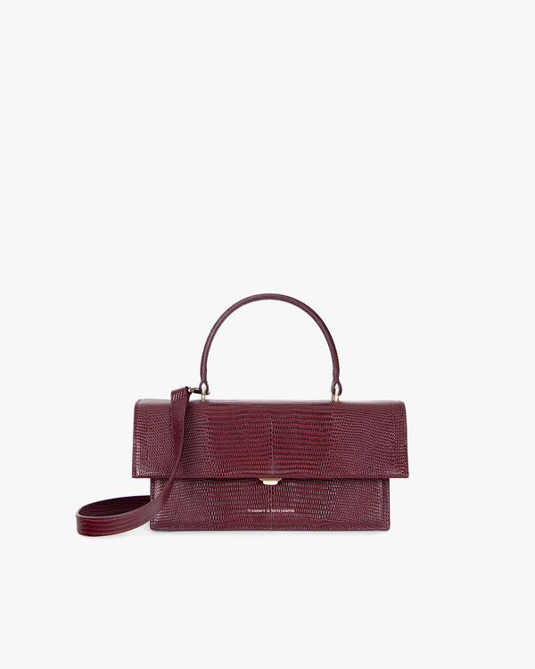 THEA bag in Bordeaux Embossed Lizard, front view, standing, with top handle and shoulder strap