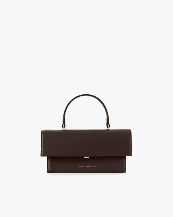 THEA bag in Chocolate, front view, closed oversized flap, top handle, on white background