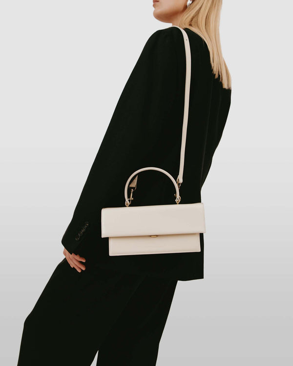 THEA bag in Ivory worn as a crossbody, side view on model