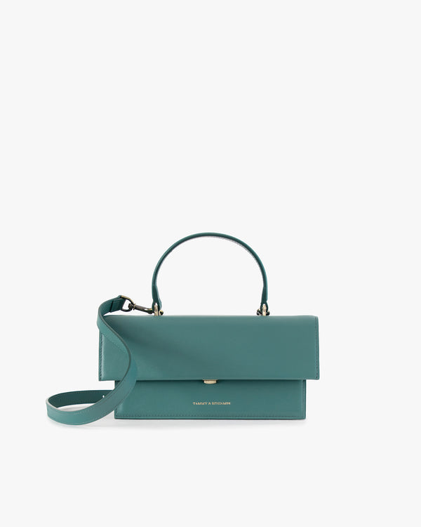 THEA bag in Turquoise, front view, flap closed, rigid handle with detachable leather strap draped in front