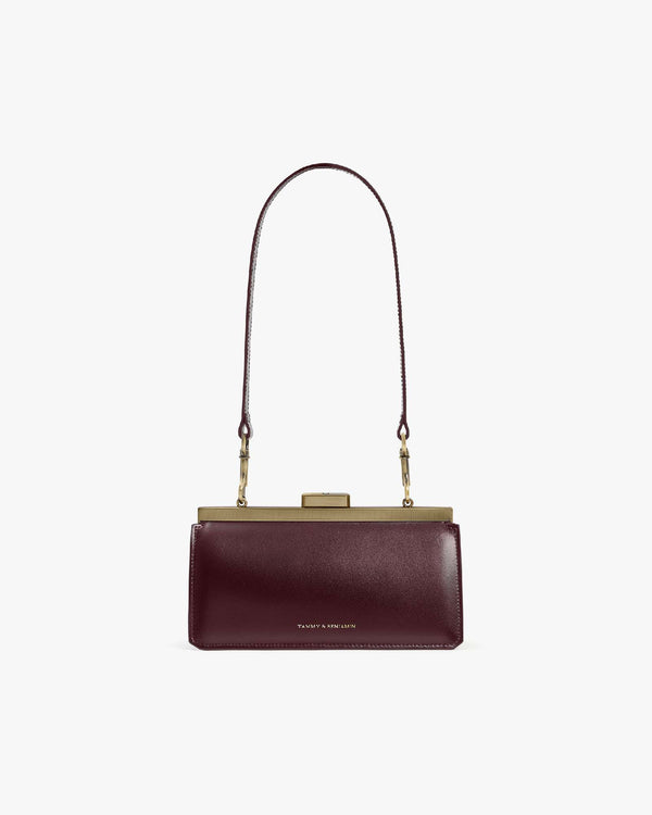 JEANNE BAGUETTE bag in Mahogany, front view with long strap, gold clasp visible