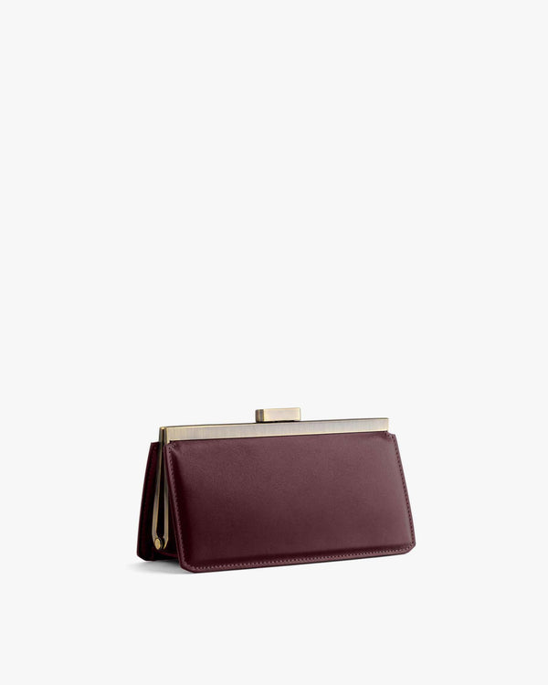 JEANNE BAGUETTE bag in Mahogany, three-quarter view, gold retro clasp visible, standing