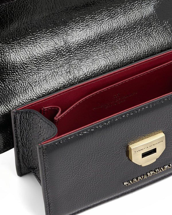 THEA MINI bag in black naplak, flap open, close-up of red interior and gold clasp