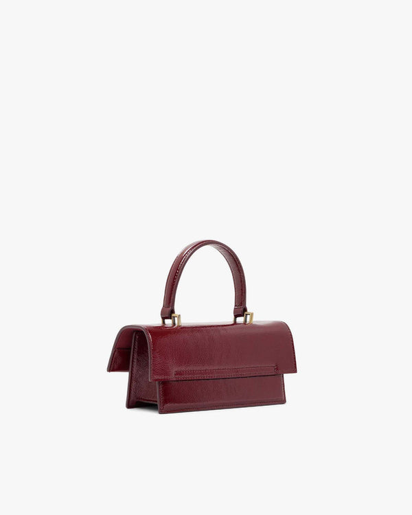 THEA MINI bag in burgundy naplak, back three-quarter view, standing, top handle raised