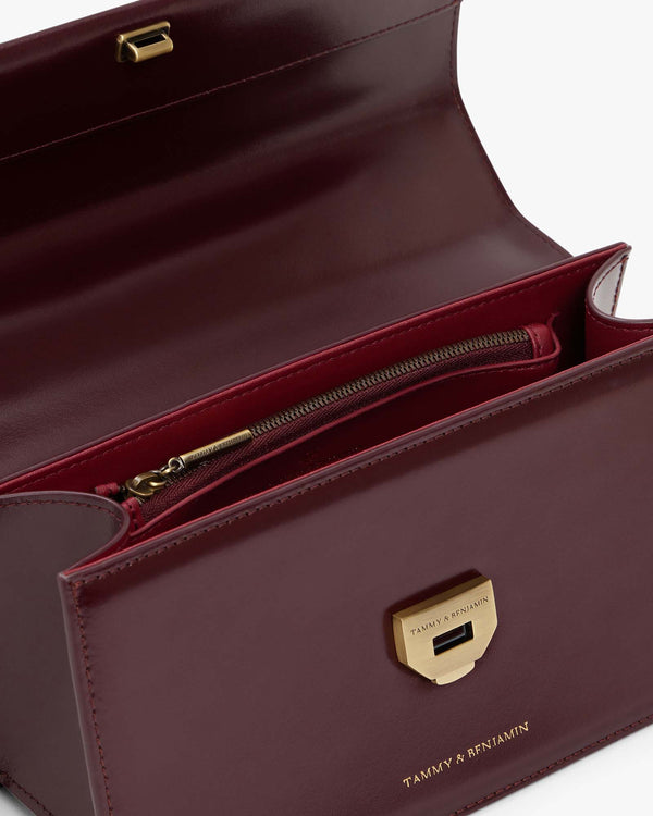 THEA bag in Mahogany, open view showing zipped pocket and gold clasp