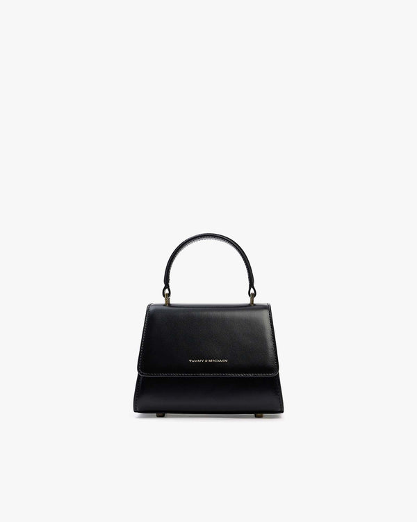 ALEXIA NANO bag in black, front view, rigid handle raised, on white background