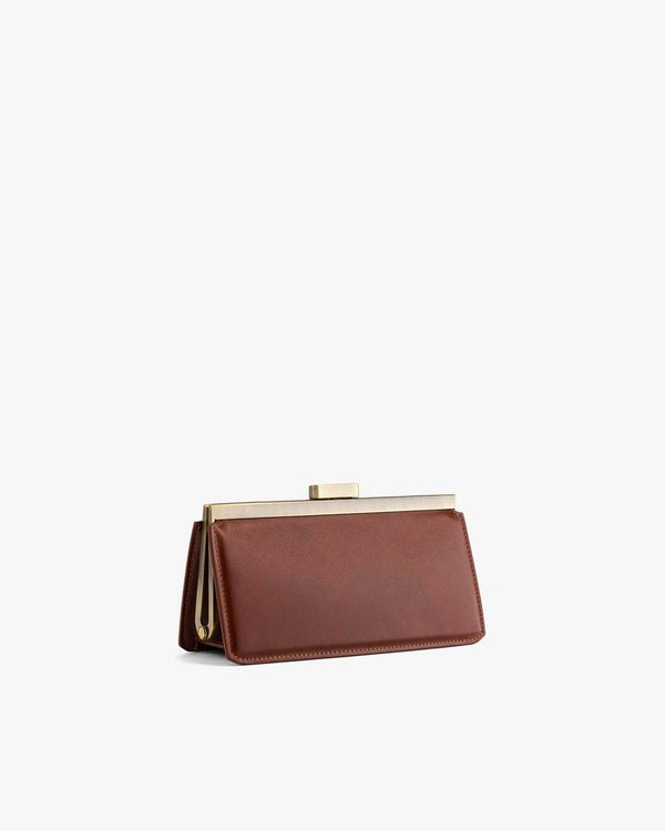 JEANNE BAGUETTE bag in brown, three-quarter view, standing, gold clasp visible