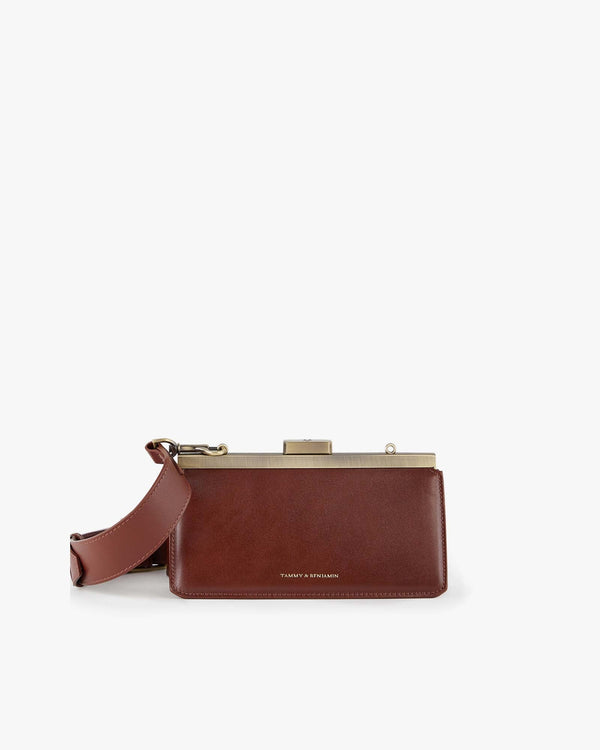 JEANNE BAGUETTE bag in brown, front view, standing, retro gold clasp and adjustable shoulder strap