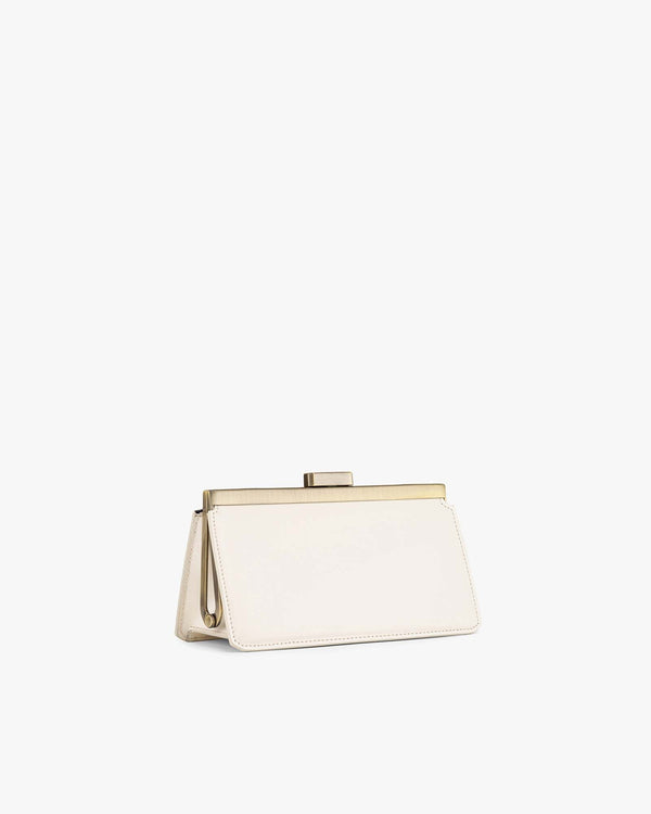 JEANNE BAGUETTE bag in Ivory, side angle view, standing with gold clasp visible