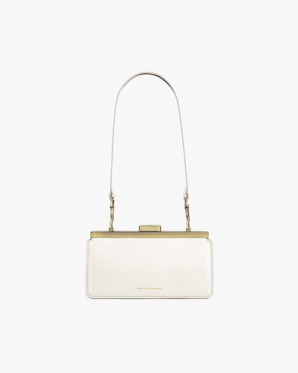 JEANNE BAGUETTE bag in ivory, front view, worn on the shoulder, gold-tone retro clasp