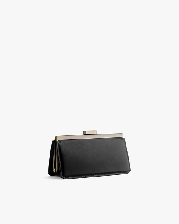 JEANNE BAGUETTE bag in black, three-quarter view, standing, gold-tone clasp visible
