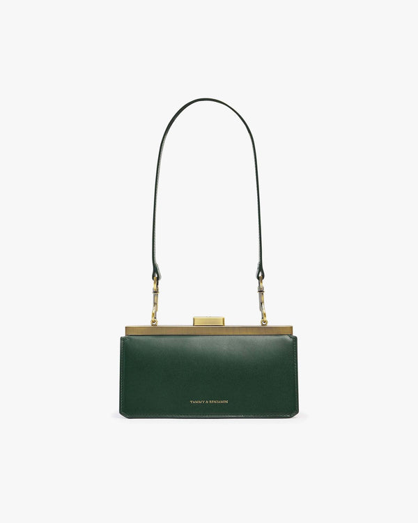 JEANNE BAGUETTE bag in emerald green, front view, standing, with long strap and gold clasp