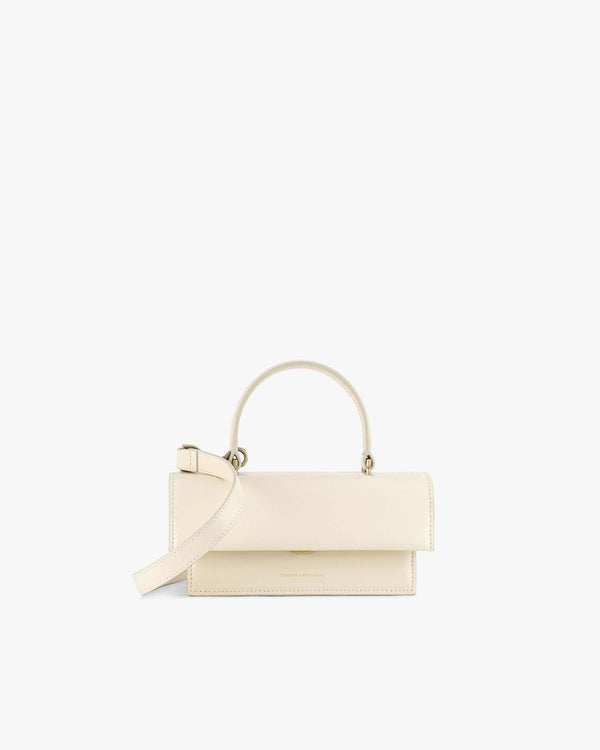 THEA MINI bag in ivory, front view, standing, with top handle and detachable crossbody strap unattached
